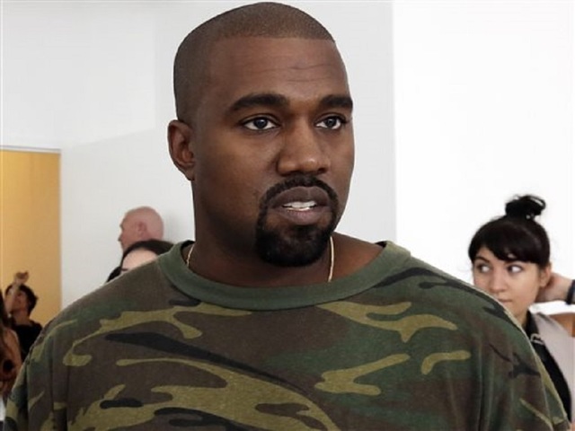 Sweaty fashion crowd lured outside for Kanye West show